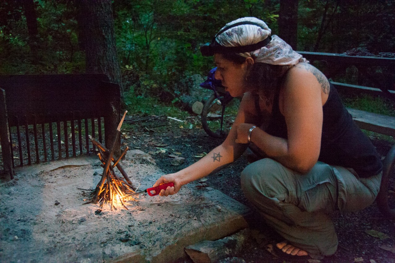 Sarah lighting the campfire